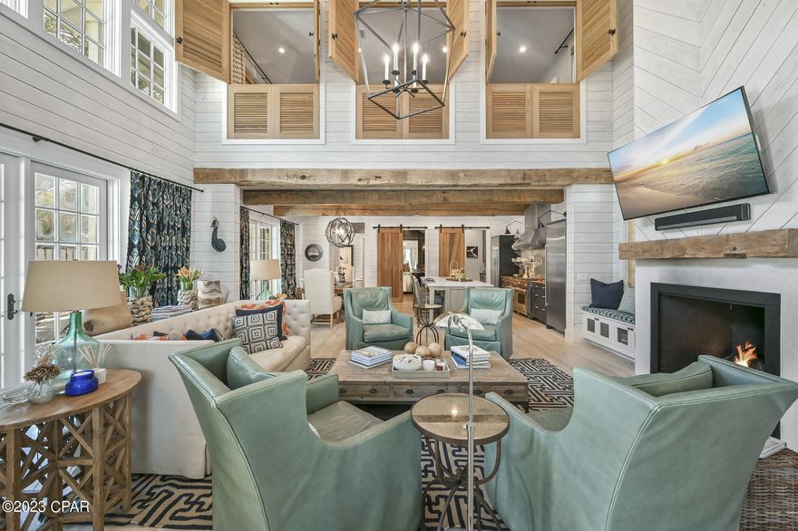 As featured in HGTV and published in 30A Style Book, this casually elegant beach home is situated behind the private gates of Watersound West Beach. Enjoy the ultimate beach lifestyle at St Joe's exclusive Watersound Beach Club, 40K member initiation fee is included at closing. Gorgeous custom beach home promises a relaxed coastal lifestyle where entertaining is warm and welcoming. This 4 bedroom, 3 ½ bath home and guest house features luxury designer touches from Tracery Interiors of Rosemary Beach, and an open-concept design where the indoor and outdoor living spaces meld together without boundaries. The gourmet kitchen is a chef's dream and reflect the owner's deep culinary roots with a massive Wolf gas range, two full-sized Sub-Zero refrigerators, and a walk-in butler's pantry. Two fully equipped wine cellars inside an exquisite bar room tucked behind custom cedar barn doors. Peacock pavers accentuate indoor outdoor living perfectly. The dining area has and array of French doors that swing open onto the pool terrace, while the living room glass doors fold open to allow the space to engage the screened porch for outdoor dining. The second floor of the house is devoted entirely to a generous Master suite with custom cedar privacy shutters, a media chaise lounge, and a luxurious spa bath with wall-to-wall Italian marble, deep soaking jetted tub and standalone his/her showers. There are two guest rooms on the main floor that share a double vanity jack-and-jill bathroom. Designed to maximize privacy, this custom home was designed for guests to have their own luxury space in the carriage house, leaving the main home a sanctuary, opened up for entertaining and pool side gatherings! The private detached carriage house offers another full bedroom, a sleeper sofa and bathroom for your weekend house guests. If you are an electric car enthusiast, the Seller has a built-in charger for a Tesla. West Beach owners enjoy one of the most expansive beaches on 30A, along with nature trails, dog parks and a heated community pool. This house is sold furnished, with some owner exclusions, and can be viewed by appointment only.