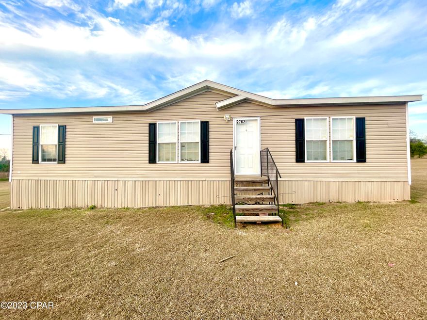 If quiet country living is what you seek then you must tour this 3 bedroom 2 bath well-maintained 2019 double wide mobile home.  A short 1/2 mile drive from 231 just south of Cottondale down a paved road leads you to this home on a full 1 acre lot overlooking neighboring pastureland.  Convenience is not lost since I-10 is 1.2 miles from the driveway.  An added 10x28 outbuilding is powered and can be used for storage or a workshop.  This place is turn-key move-in ready and won't last long.  Lock it in before it's too late.