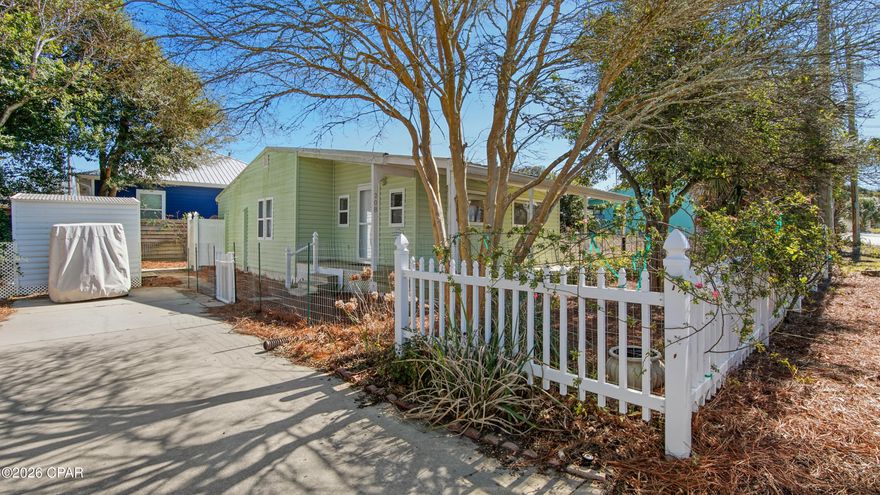 Welcome to 208 El Prado Place! Cute 2 bedroom Florida beach cottage on the West end of Panama City Beach. Located in Laguna Beach, only two blocks from the beautiful white sandy beach and emerald waters of the Gulf. Close to Pier Park and Top Golf to the East, and to the shops and restaurants along scenic 30-A to the West. It's just a short walk or golf cart ride to the dedicated Laguna Beach access points, and also to the Carousal Grocery Store and Thomas Donuts, popular with both locals and year round visitors.  
This cottage has an updated kitchen, all white cabinets, quartz countertops, ceramic sink, and appliances, including stove, refrigerator, built-in microwave and stackable washer and dryer. The Master Bedroom has a door that opens on to the back deck, and the updated Bathroom has a shower/tub combo. There is a large covered front porch that wraps around and extends along the length of the house. Perfect for sitting outside with your morning coffee, or for relaxing after a day  spent on the beach. There's a Meyer lemon tree in the front yard, and pink roses that grow along the white picket fence in the Spring and Summer. Driveway parking, plus extra parking space at the front of the property. Short term rentals allowed. No HOA. Don't miss the opportunity to make this your very own beach house, vacation cottage or rental investment property! ** Please note - The floors need to be replaced in this home.