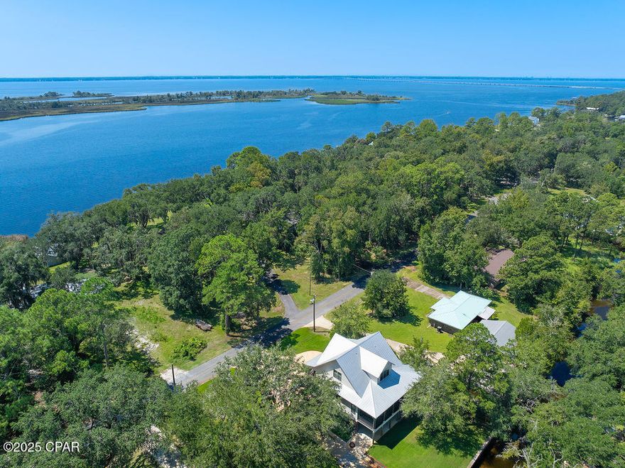 Discover timeless coastal elegance in this exceptional canal-front luxury home where classic Southern architecture meets the tranquility of 'Old Florida' charm. With 130 feet of protected canal frontage and a boat lift, it is an easy boat ride to Choctawhatchee Bay. You can relax on the front porch deck while taking in the view of the bay, or settle in on the back screened porch, overlooking the lush yard and canal. This home boasts three stories with an elevator for your convenience. The well-appointed kitchen meets the needs of any chef, with a butler's pantry and plenty of counter space! The open floor plan allows for easy entertaining across the main living areas. This property delivers a rare blend of privacy, elegance, and waterfront lifestyle, an ideal sanctuary for you.