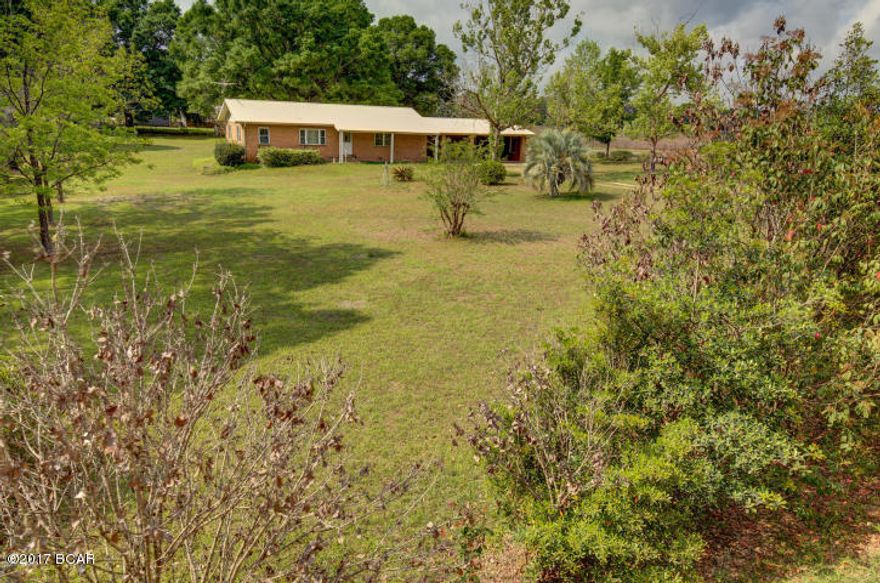 REDUCED!!! MOTIVATED SELLER.... Ranch Style Brick Home comes with 1.32 acres, Split Bedrooms, 3 Bedroom, 2 Bath, Kitchen with lots of Cabinets, Inside Utility Room, 3-Car Attached Carport with storage rooms, additional 1 Storage Shed with 1 Car Detached Carport, Enclosed Detached Storage Shed used for storing Antique Cars with Garage Doors on each end, Private Well, Private Septic System, and many extras. Schools = Grand Ridge School (K-8) and Sneads High School (9th-12th). Just 12 minutes from Marianna I-10 and all convenient stores, restaurants, and much more...Call Listing Agent for more details on this lovely home. All measurements are estimated.