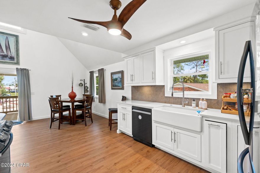 PRICE REDUCTION! Back on the market at no fault to the seller's.  A beautiful beach home that has been completely renovated! Nice and quiet neighborhood, with a short drive to Panama City Beach and Grand Lagoon. Just minutes from Bay Point and the Navy Base. The living space is bright and airy with plenty of natural light. 18ft vaulted ceilings, beautiful wood floors, and speakers in the ceiling. The kitchen boasts custom shaker cabinets, stunning quartz countertops, and an apron sink. Living space leads out to the 2nd story deck, a great place to start your mornings or unwind in the evenings. There are two nice sized guest rooms on this floor, as well as a beautiful guest bath. 3rd Story is a private master suite with walk-in closet, jacuzzi tub, and powder station. Amazing, reclaimed hardwood on this floor. Home is on stilts, so the first story offers plenty of parking, enclosed storage, and a great patio space for entertaining family and friends. Additional storage building behind the home, and plenty of side yard for an inground pool. Owners have spared no expense in upgrading and designing. New roof 2021, Septic system 2022, all windows 2021, a/c unit 2022, water heater 2024, all new appliances 2022. Pride of ownership shows throughout. One of the best locations at Panama City Beach! Schedule your visit today!