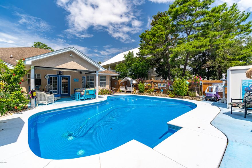 4bd, 2ba (fully furnished) main home with a pool...and an air conditioned 200+ square foot separate guest cottage with a full kitchen and bath! Home has a quaint sun room/bar that leads to an outdoor covered patio set up as the perfect lounging area. This home fits every category! Primary residence, 2nd home, or absolute CASH COW if used as a rental. Previous owners cleared a path through the backyard that takes you straight to a fresh water lake(full of bass and croppy fish) and a walking path that is no more than a 5 minute walk to the Pier Park amphitheater. THIS GOES QUICK!! All information is approximate and should be verified by buyers if important