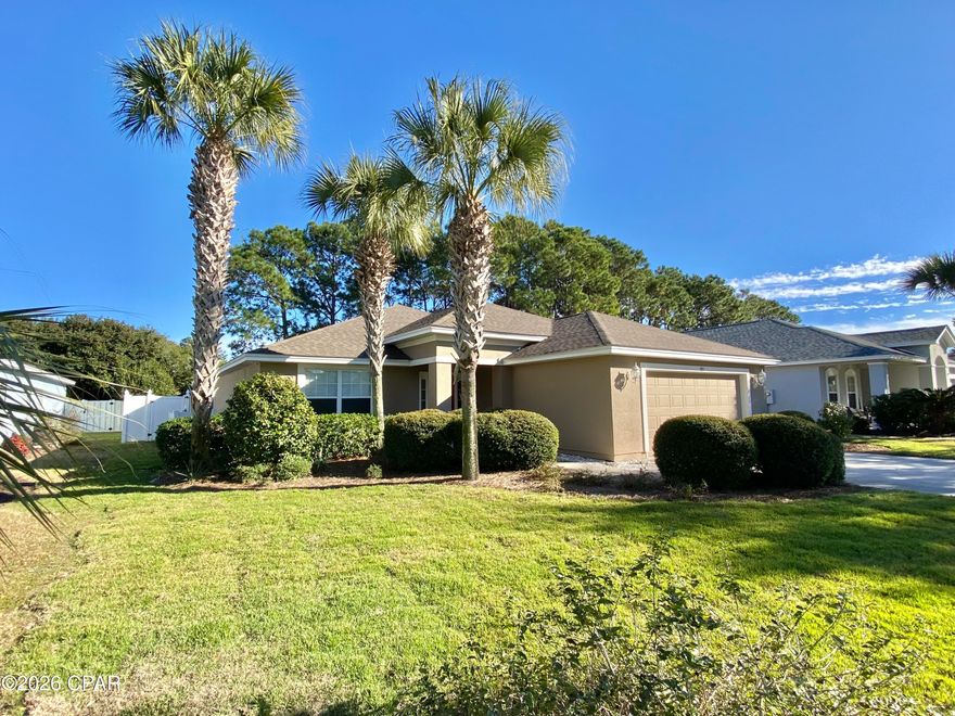 WELCOME to Palmetto Trace a well-groomed community nearing most anything you would need. A golf cart community that has access to Pier Park, grocery stores including Walmart, too much to mention! An HOA community with a minimal yearly charge that includes Management; Pool; Trash Disposal, Pool maintenance and sidewalks. 
Very common to see folks walking their dogs, chatting in a neighborly manner, jogging, riding bikes and golf carting to close by businesses. 
This immaculate 4B 2 bath split floor plan 
home boasts high vaulted ceilings, open concept living room, dining room and kitchen. Upscale appliances complete with a gas stove, Corian countertops, Island with breakfast bar and a multitude of cabinets.
Large spacious master bedroom and bath with his-her sinks, soaking tub, walk in shower and huge walk-in closet. Other side of the home has a closed door 2 bed and bath suite and 4th bedroom or office off the large voyeur in the front of the home. A spacious 2-car attached garage and laundry room convenient yet out of site. Newer roof, AC, Water heater and Not in a flood zone insurance is affordable. This home also provides a nicely landscaped back and front yard with crepe myrtles, palm trees and various shrubs. A white low maintenance 6-foot privacy fence with 2 side gates for ingress/egress exists along with a very large covered back patio complete with ceiling fans could be a closed in Florida room. At this price this won't last long! Schedule your own private viewing today! Buyer and Buyers agent to verify all dimensions and anything deemed important.
