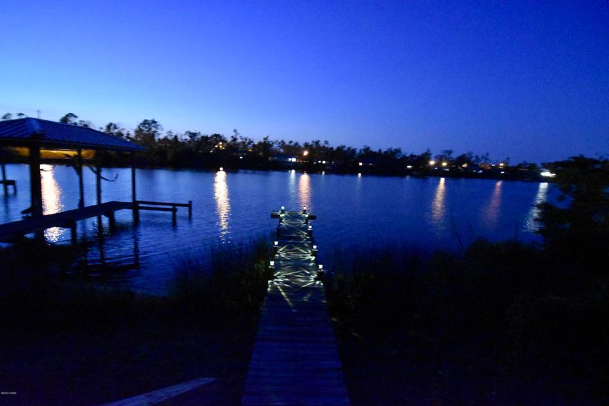 CHARMING WATERFRONT HOME with breathtaking water views! A well-kept home in a great location and fully renovated! Located only minutes to Tyndall AFB, beaches, restaurants, shopping, etc. Over 1630 sqft, 3 BR/3 BA - ready for your family. This home makes you feel secure, with a newer, well constructed, metal roof and hurricane-rated windows.  As you enter the home, you can't help to feel the warming atmosphere, highlighted by the porcelain wood looking tile flooring, custom fixtures, and contemporary lighting. The living room captures the essence of luxury in showcasing large wood beams on vaulted ceilings and an eye catching fireplace. The new kitchen offers stainless steel appliances, granite countertops, and soft-close throughout. Enjoy sunsets from the oversized wood deck or dock!! The large master bedroom won't disappoint; wake up to the gorgeous views of the bayou. The masterbath features a double vanity with walk in shower.  The 2nd full bath also offers a bathtub, high grade sink, and modern feel. The master and addition bedrooms are spacious and inviting with ample closet space.

This home offers 32' of waterfront, 27' x 10' screened patio, large 24' x 18' deck, 35' walkway/dock and some of the best outdoor living you can experience! This outdoor retreat is an entertainers paradise.  Relax and unwind from your screened patio, large deck or capture the serenity of the water while resting on your dock overlooking the Callaway Bayou.  

Seller does not have to pay flood insurance; listing includes elevation certificate.  Call for your private tour today ... it won't disappoint! Measurements approx; verify if important.  All UPGRADES LISTED BELOW

Curtains and Curtain Rods do not convey.   

UPGRADES:
Downstairs:(all new)
2015: porcelain tile flooring, baseboards, kitchen (soft-close everything), appliances,  French doors (Florida room entry), all  light fixtures/fans excluding the one above the sink, 1/2 bath renovation (mirror, vanity, toilet, towel rack).

Upstairs:(all new)
2016: 2ea bathroom tubs/shower upgraded through Bath Fitter w/ new fixtures
Metal roof (double checking on transferability of warranty)
New hurricane-rated windows (through Home Depot, warranty is transferrable)
New Blinds (wooden blinds in house, synthetic blinds in garage) 

2018: Cork flooring on the stairs, vinyl Lifeproof flooring everywhere else, baseboards, light fixtures/fans excluding closets, 2 full bathroom renovations (custom vanities, vessel sinks, toilets, towel rack; new interior doors