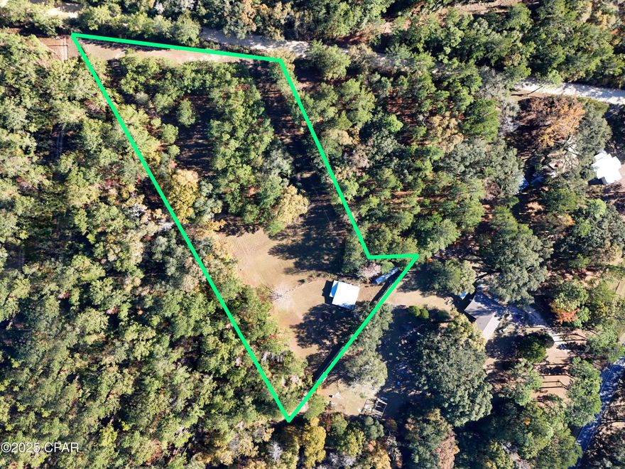 Escape to your own private retreat with this one-of-a-kind property offering endless potential for a homestead, hunting camp, weekend getaway, or off-grid living opportunity. Situated on nearly 3 acres, this unique setup combines privacy, functionality, and room to make it your own.

According to the Property Appraiser, the structure was originally built in 1950 with an effective year built of 2022, and may have originated as a barn that has since been thoughtfully transformed into living space. Interior features include a concrete foundation, vinyl flooring, paneling and sheetrock walls, and wood-sheathed ceilings for a rustic yet comfortable feel. Electrical has already been installed, with designated spaces ready for a future kitchen and bathroom, while plumbing remains unfinished for the next owner to customize.

The property also includes an outdoor shed currently serving as a bathhouse, a window A/C unit, space for two bedrooms, a covered front porch, and an attached carport. Approximately Â¾ of an acre is level and mostly cleared, providing plenty of usable space for gardening, animals, recreation, or additional improvements. Partial fencing is already in place and could easily be repaired or expanded. A tractor trailer used for storage will also convey with the sale.

Whether you're looking to simplify, start a mini homestead, or create a secluded getaway, this property offers a rare opportunity with plenty of potential. Property is being sold As Is. Buyer to verify all information and perform their own due diligence.