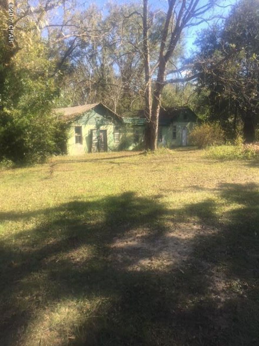 1 Acre parcel on the corner of Collins Rd and Hwy 73 South.  It is mostly cleared with scattered trees.  There is an old building on the property that is in need of extensive repair.