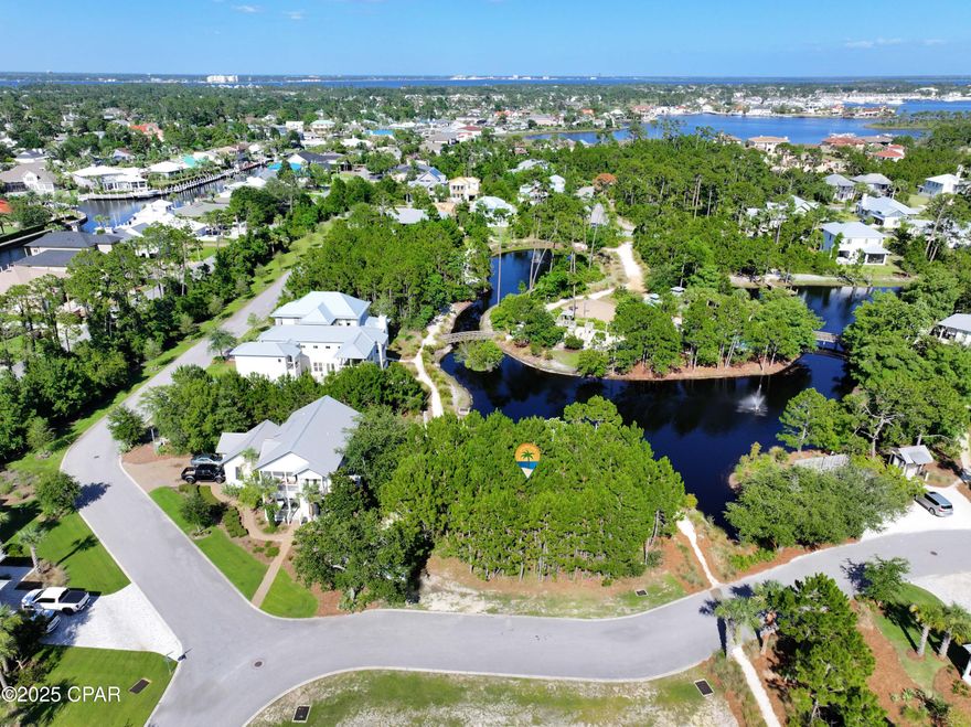Build your dream home on a distinguished waterfront lot overlooking a peaceful pond enhanced by a beautiful, cascading fountain. Located in the highly sought-after gated community of Martinique, this property offers an exceptional lifestyle surrounded by natural beauty and upscale amenities.

Residents of Martinique enjoy picturesque walking trails, natural paths, a large community pool, park pavilion and gazebo, basketball court, and children's playground—all within a setting known for its lush landscaping and tranquil ambiance.

Ideally located just minutes from the stunning beaches, St. Andrews State Park, and local dining and shopping, this property offers the perfect blend of relaxation, convenience, and coastal charm.

Don't miss this opportunity to build your custom dream home in one of the most beautiful and desirable neighborhoods along the coast.