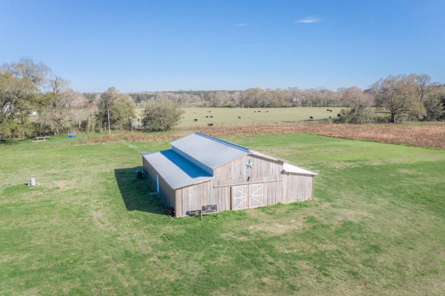 What an Investment Opportunity... Improved barn with around 12 acres... Currently being used as a Wedding Venue and with confirmed bookings. Short distance from Graceville. Barn is (48x72) 3456 sq ft of heated and cooled space. Two 1/2 baths with dressing room and so much more.