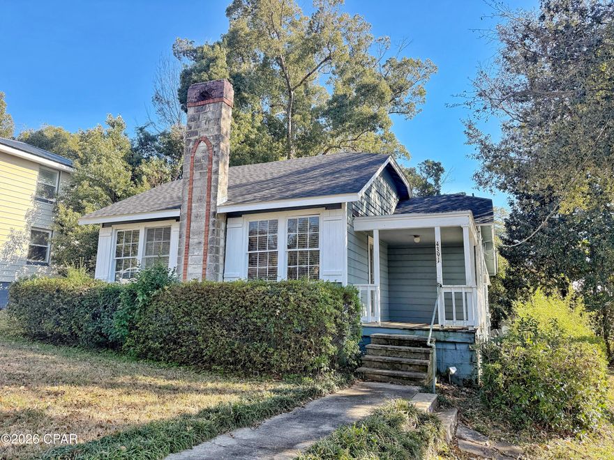 Charming downtown Marianna cottage with tons of potential! This 2 bedroom, 2 bath fixer-upper offers great curb appeal and sits directly across the street from a city park—an ideal location for enjoying small-town living. Inside, you'll find a main living area featuring tongue-and-groove paneling and a fireplace, just waiting to be brought back to life. With some TLC, this home could once again be a cozy retreat full of character. Situated on a desirable corner lot with mature trees, the property also includes an extra storage shed for added convenience. Perfect opportunity for investors or buyers looking to restore a classic Florida cottage.