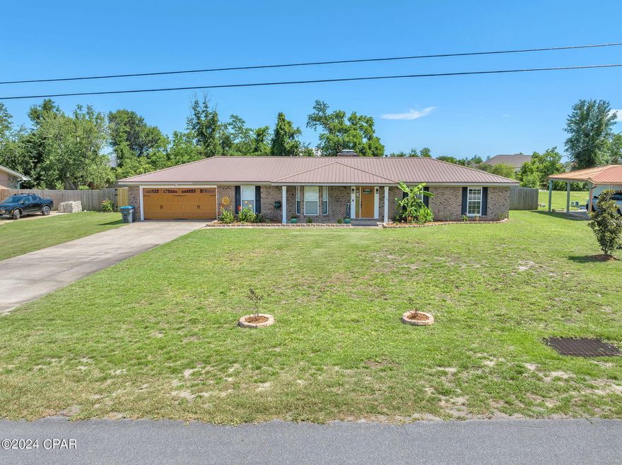 CURRENTLY UNDER CONTRACT, SELLER WILL CONSIDER BACKUP OFFERS 3 Bedroom/2 Bathroom BRICK home + Bonus room & Workshop sitting on a HALF acre lot in the highly desired Lynn Haven area! With space to make your backyard dreams come true; Exterior boasts a covered front and back porch, fenced backyard, playground, paver fire-pit, and 20x24 heated and cooled workshop/garage. Interior showcases luxury vinyl plank flooring throughout all common areas. Spacious formal entryway leading to an open concept kitchen/ living. Situated off the entryway sits the large bonus room with bay windows and formal dining area. Living room features a bricked wall wood burning fireplace, and accent wall overlooking the beautiful kitchen. Kitchen showcases a large island/breakfast bar with underneath cabinetry, Quartz countertops, stainless steel appliances, 
built-in microwave, deep stainless steel sink, tile backsplash, and recessed lighting. Large mud room/ laundry room sit off the garage and back door. Bedrooms feature carpet flooring; Guest bathroom features tiled shower/ tub combo. Master bedroom and en-suite features a tiled shower, and built-in dresser storage. HVAC fully replaced in 2020 with UV purification system, new well pump 2023, new metal roof on workshop 2021, shed built in 2022 with extra attic storage, kitchen remodeled 2018, 4 zone irrigation system and metal roof on main home is 11 years old. Call to schedule your private showing today! All Measurements approx. buyer to verify if important.