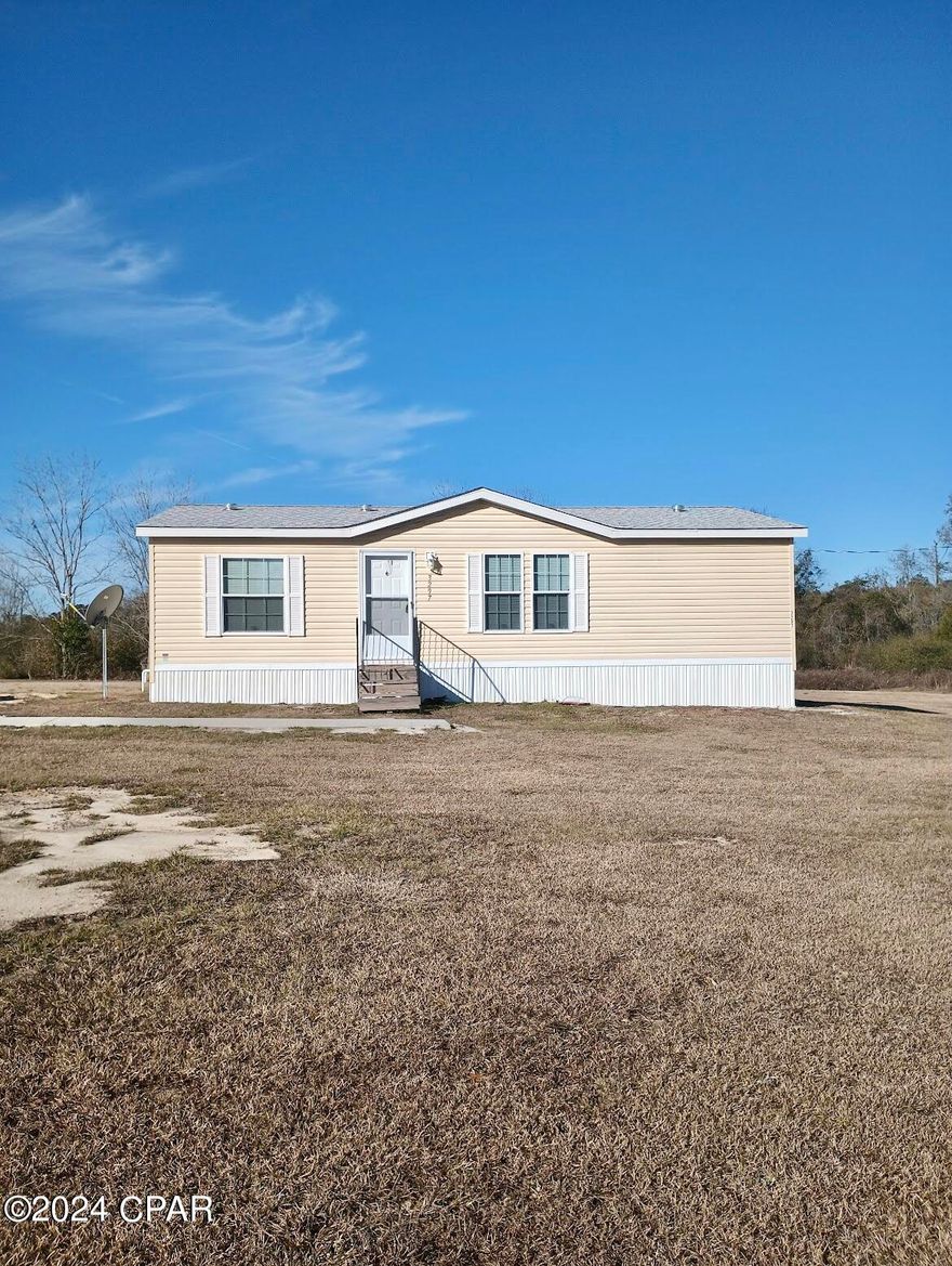 Welcome to your future home, a cozy manufactured residence on a spacious 1-acre corner lot. This 2-bedroom, 2-bathroom home has been upgraded to enhance your everyday living experience. This home is Wind Zone 3, boasting enhanced structural integrity, surpassing standard wind resistance with upgraded zoning for added safety. Step inside to find the thoughtful addition of molding and wall plastering. Upgraded flooring + ceiling insulation adds to the energy efficiency of the home. Security and efficiency are prioritized with exterior storm doors and double-hang clad sun and soundproof windows. The architectural shingles not only protect the home but also contribute to its overall appeal. Inside, practical conveniences await. Comfort height toilets, an Aquatic tub/shower, and a closet barn door add functionality to daily life. Efficiency is key with a 40-gallon Rheem electric water heater with ''easy access'' door, and a Maytag commercial washer/dryer set. The kitchen is well-equipped with a built-in microwave, refrigerator, and an electric range stove. An under-counter beverage cooler adds a touch of convenience, making entertaining a breeze. The septic has been recently inspected and pumped and well has been inspected and has had a complete overhaul from the wiring to the pump + piping. This entire property is ready and waiting for its new owners! As a bonus, furnishings can stay with a full-price offer, making your move-in process smoother. The location is also perfect. No flood zone, right off of Hwy 79, only 1 hour to Panama City Beach, and only 10 minutes to downtown Bonifay. FHA & VA loans accepted also! Schedule a showing today and experience comfort and functionality in a relaxed country setting.