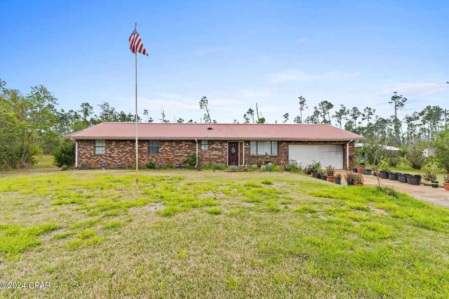 Investor Special! ARV $350k This one owner, all brick, home sits on over 4 acres of land just 10 minutes from shopping, restaurants, and more with easy access to Eastern Shipbuilding and Tyndall Air Force Base. The home features a 2 car garage with a laundry room, a good size shed and covered carport in the back that is perfect for a boat or riding lawnmower, a large master bedroom with double closets that could easily be made into a large walk in closet and an ensuite bath. All the rooms are good size. The kitchen has been updated in years past with new cabinets and tile counter tops. There is a formal living area as well as a den area and a large enclosed florida room off the back of the house that is perfect for bird watchers and wild animal lovers. With the right upgrades and repairs this home could make for a great investment. According to the County the lot cannot be divided. Feel free to verify. There is a broken floor joist in the master. CASH BUYERS ONLY. BRING ALL OFFERS.