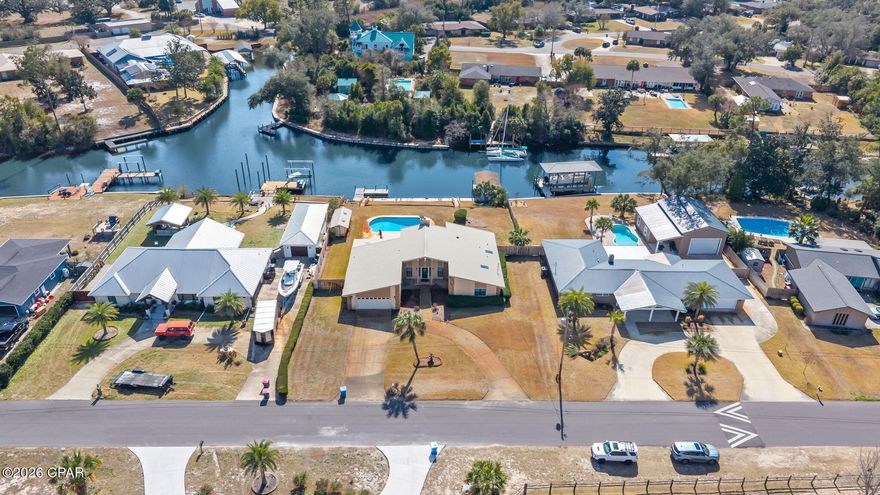 Welcome to an exceptional opportunity to own a waterfront home in the desirable Kings Point area, offered under $600,000 with a POOL and NO HOA! Situated on deep water along a wide canal, this highly desirable homesite offers higher elevation, expansive water views and quick access to the Bay and Gulf within minutes.

With approximately 110 feet of waterfrontage and located on a large canal opening, the property provides panoramic water views and excellent boating access. Enjoy fishing from your private dock or take a short boat ride to the open Bay and on to Shell Island. This central Panama City location also places you just minutes from Publix, shopping, dining, and approximately 15 minutes from the white sandy beaches.

This single-level home offers just over 2,300 square feet with 3 bedrooms and 2 bathrooms and a cozy sunroom. Inside, vaulted ceilings and dentil molding add character, while a stone fireplace anchors the living room overlooking the pool and canal. The open layout includes a spacious kitchen with newer stainless appliances, center island, pantry, and an eat-in breakfast nook with water views. A formal dining room overlooks the pool, and a sunroom provides additional access to the outdoor living area.

The oversized primary suite faces the waterfront and includes a walk-in closet, dual bath vanities, separate makeup vanity, and walk-in shower. Two additional bedrooms feature walk-in closets and share a guest bath. Additional highlights include a spacious laundry room and a two-car garage.

Outdoors, enjoy a covered porch, private pool, circular driveway, and a location directly across from the community park. This well-maintained home presents an incredible opportunity to personalize a waterfront property with year-round boating, fishing, and sunset views right from your backyard.

Waterfront living in Kings Point is now within reach! Start living your best waterfront life today in Panama City, Florida!