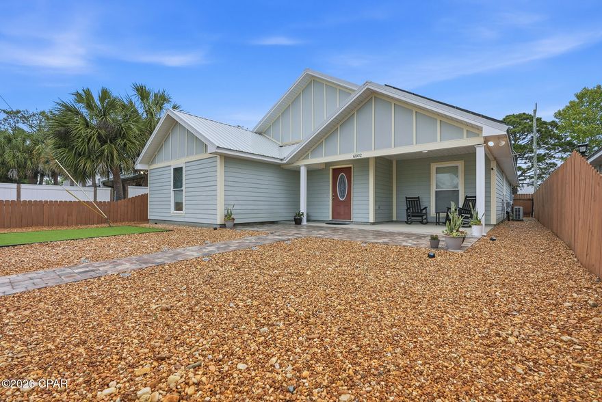 Spacious and beautifully maintained home offering views of Grand Lagoon and loaded with valuable upgrades! Enjoy energy efficiency with fully paid-for solar panels, a new A/C system featuring Air Master purification technology to help reduce odors, dust, and germs, and a new water heater. The durable metal roof (approximately 5-6 years old) comes with a 40-year warranty, peel-and-stick underlayment, and is built to withstand winds up to 200 mph for added peace of mind.  Inside, this beautiful home features soaring vaulted ceilings, tile flooring throughout the main living areas and bathrooms, granite countertops with undermount sinks in both the kitchen and baths, stainless steel appliances, and a new refrigerator. Additional upgrades include a RainSoft water softener and a Clean Start ozone laundry system for enhanced efficiency and convenience.  Step outside to enjoy the low-maintenance landscaping complete with decorative rock accents, extended pavers, and turf grass designed with pets in mind. The large covered patio creates the perfect space for entertaining or relaxing, while the oversized two-car garage offers plenty of extra storage.  A perfect blend of comfort, efficiency, and style in a desirable lagoon-view setting--call today for additional details!