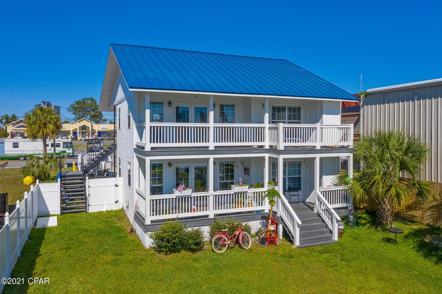 Location, Location Location!!! This completely renovated duplex sits on a water front lot offering a dock with several boat parking options and a covered area to sit and enjoy the lagoon. You will be within walking distance of many great restaurants, water craft rentals and other activities.  By boat only 3.6 miles to the pass and 3 miles to Shell Island! This duplex is on city water and city sewar and would be a fantastic rental! occupy this home with an income producing floor below. Each unit is 2 bedrooms and 2 bathrooms just under 1200 square feet. In this property you will find a fully renovated with top-of-the-line stainless steel appliances, washer / dryer in each unit and a private deck. When you first enter each unit, you will notice a very nice full kitchen to your left with a wi