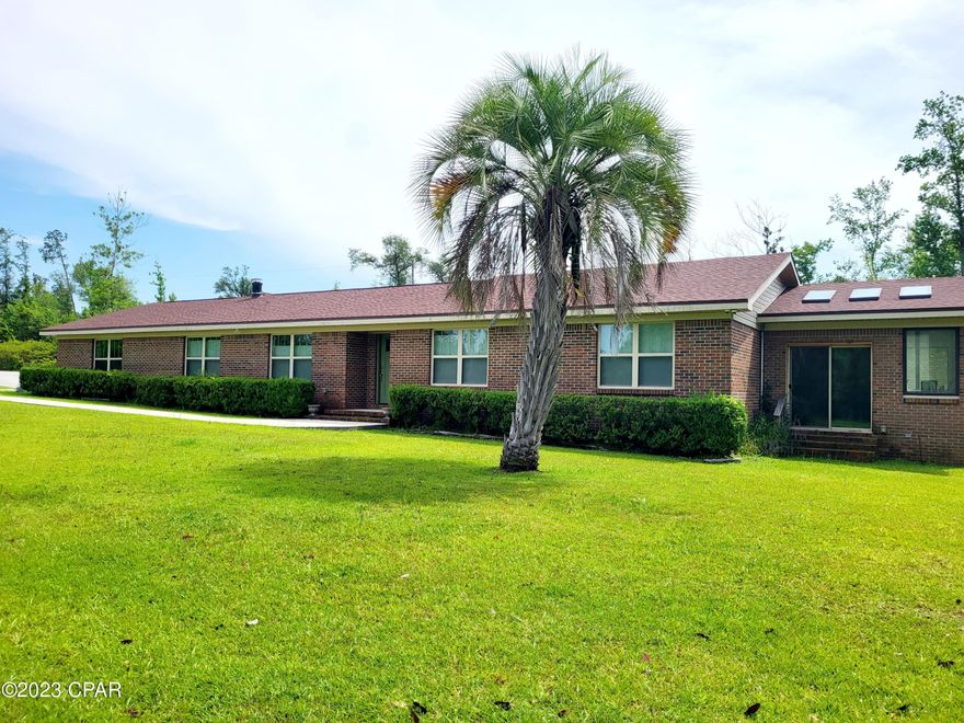 Beautiful Mother-In-Law attached Suite for the Extended Family!  This beautiful 3/2 Home on 5 acres has more than you will need!  Enjoy the large Master Suite with step down Sun Room and beautiful natural light. The Master Bath has an oversized walk in shower with double vanities and lots of extra storage.  This Open Concept Living - Dining - Kitchen has been completely remodeled and everything is perfect for entertaining and just enjoying your beautiful home!  French doors lead to a large enclosed breezeway that adds even more space for your  family and connects to the beautiful upgraded Mother-In-Law suite.  Beautiful Granite Countertops, New updated Stainless Appliances, Washer and Dryers in both Home and Apartment.  Wood Pellet Burning Stove in the main house for that extra warmth in the cold months.  Double sided Fireplace with electric log fire for ambience and warmth!  There is a large Screened in Porch with a swing and plenty of room for entertaining outside.  Need a Large Workshop?  This one is amazing! Everything you need to store your equipment, boat and still room for all you tools and hobbies! Don't worry about a Generator - this home is completely set up with a Generac whole house Generator!  5 acres of privacy!  All this and close to town!  Take a look at this home and make the move!