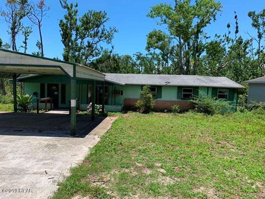 Block house centrally located in Panama City situated on a dead end street. This home features large rooms, bonus rooms and amazing potential. There is a laundry room interior to the house as well as covered back porch. The home backs up to private vacant land so the setting is serene the dead end street insures a low traffic count.