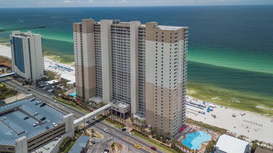 Enjoy endless gulf views & magnificent sunsets right from your living room & bedroom. Tidewater unit 401 is a spacious corner unit with a 60'' wraparound balcony featuring 3 bedrooms/3 baths + a bonus 4th bunk room. This fully furnished unit is rental ready & can sleep up to 14! It is the perfect height too---just high enough from the noise but low enough to see all the activity on the beach & in the ocean! There is a utility room, spacious open living area, granite counters, & 9' ceilings with crown molding. A large master suite features a cozy window nook with plantation shutters overlooking the Gulf, a sliding glass door to the gulf front balcony and an in-suite bathroom with double sinks, a garden soaking tub, a separate shower, and a huge walk-in closet and much much more! Two additional guest bedrooms round out a great unit! There is so much storage in the unit and if that isn't enough, there is also a double storage cage in the 4th floor stairwell which conveys with the unit. This is the perfect home away from home right on the beach! Tidewater Beach is a Premier Resort with many amenities including a heated indoor pool, 2 outdoor lagoon pools, movie theatre, work out facilities, a game room, meeting rooms sky-view owners lounge. And you can't beat the close proximity to both the airport & Pier Park with all the shopping and dining options.