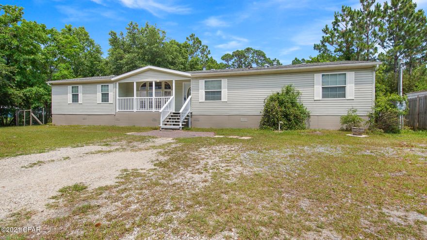 Awesome 4 Bedroom 3 Bath Triple Wide in West Bay! This large home is located just 5 minutes north of The Worlds Most Beautiful Beaches. The home features an expansive split floorplan layout with a large living room, den with fireplace, and massive kitchen and dining area. The Master Bed and Bath features a Double Vanity and Garden Tub with separate walk-in shower, a large walk-in closet, and a private office/nursery area with a walkout access to 1 of 3 large porches. Outside the property features a fully fenced back yard shaded with hardwoods, 1 of 2 yard buildings, and a beautiful pond! Convenient to restaurants, shopping, and the beaches but without all the noise. Call to schedule your showing today!