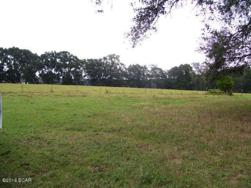 This beautiful piece of country comes ready for pasture and farming. 1981 Doublewide mobile home has caretakers living in it at present. Two huge equipment and hay barns with 2 wells and septic on land. Hay business at present but has been a cattle ranch before. Coastal and Bahia fields all high and dry. Approximately 10 acres in wetland/ponds. Lovely big oaks shade buildings and mobile home. There is a deeded ingress and egress road, owner will improve after hay season. Take a tour with owner or caretaker and you will admire the land and love the price!!!