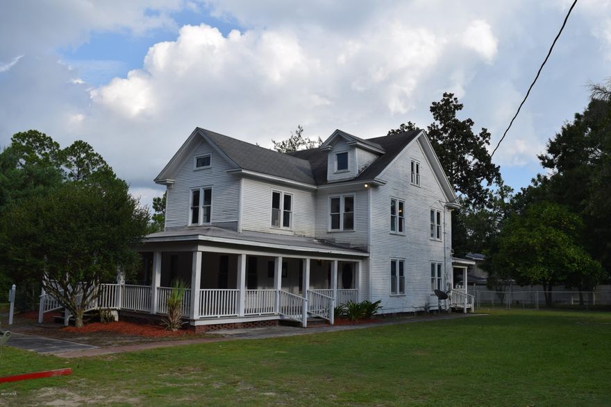 Own a piece of Lynn Haven history! Step back in time with this historical home built in 1915!  The Triplett House is a two story Victorian on 5 lots in a great location. Enjoy unobstructed views of Anderson Bayou from the huge wrap around porch. This home has over 3200 square feet of amazing potential. And if that's not  enough, the large attic is ready to become the third floor. Original pine floors, original doors,  and  transom windows are just a few of the nostalgic features of this enchanting home. Restored to its original glory, this home would make a grand residence or maybe a Bed and Breakfast.  There is a parlor, a living room, formal dining room, 2 kitchens, potentially 6-8 bedrooms,  3 full bathrooms, 2 sun rooms, a huge laundry room/mud room, and one whole room designate the master closet. The home is currently divided into 2 separate residences with 2 full kitchens and was originally built by the Triplett family as a boarding house. The beautiful, sprawling yard has large trees and a fenced in swimming pool.