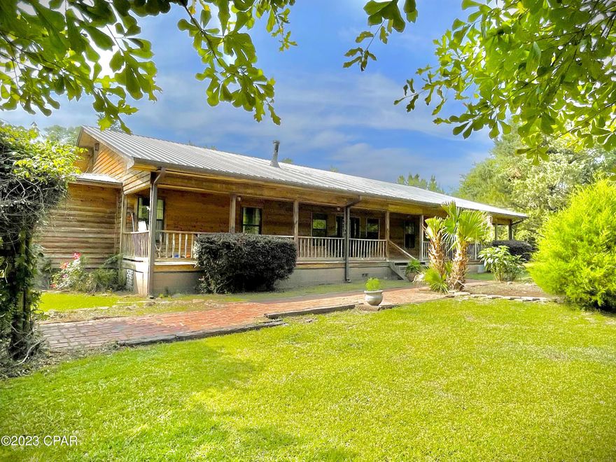 Back on the Market, at no fault to the sellers! Looking for a POOL house with acreage in Marianna? Don't miss out on this 2,336 sq. ft. beautiful cedar sided home that features a large living area and 4 bedrooms and 2 full baths. Upon entering the front door, you are welcomed by a large open living area, dining room and kitchen. Off the left of the living area sits the master bedroom with his and her walk in closets, an office, and large master bath. To the right of the living area sits three more bedrooms and full bath. The outside of this home features two large porches one on the front and the other, a screened porch, on the back. A pool with an attached hot tub in the backyard in perfect for summertime entertainment! Call today, you don't want to miss this one!!