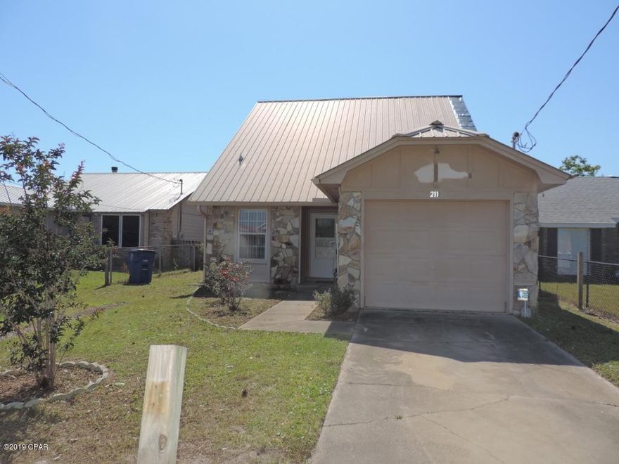 Great home located in central panama City, close to park, schools and shopping.  Home has some damage from hurricane Michael.  This is a great 3 bed 2 full bath home. Master is located on the first floor with its own ensuite, two additional bedrooms, a full bath and a loft area are located on the second floor.  Come make this home your own.  Great back yard with a screened in patio and a large storage shed/workshop!  This will not last call today! This is being sold AS IS.