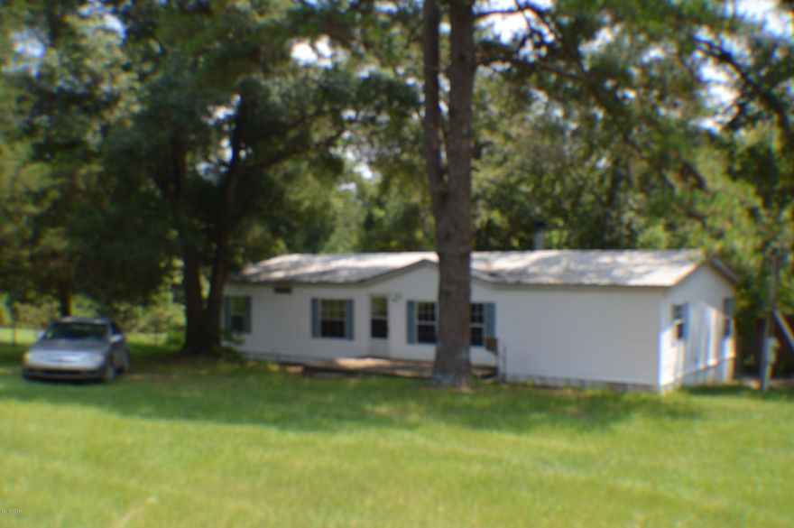 BEAUTIFUL 16 ACRES WITH A 3/2 DOUBLE WIDE HOME SOUTH OF CHIPLEY. THE HOME HAS A NEW METAL ROOF, NICE COVERED BACK DECK AND A FRONT PORCH. HOME HAS A NICE WOOD BURNING FIRE PLACE AND LARGE KITCHEN WITH APPLIANCES. HOME HAS NEW LAMINATE FLOORING THROUGHOUT THE HOME. MASTER BATH HAS SEPERATE SHOWER AND GARDEN TUB. THE PROPERTY HAS 2 WELLS AND A SPRING AND ALSO A WORKSHOP WITH A 2 CAR CARPORT. THIS PROPERTY IS A MUST SEE REALLY NICE.