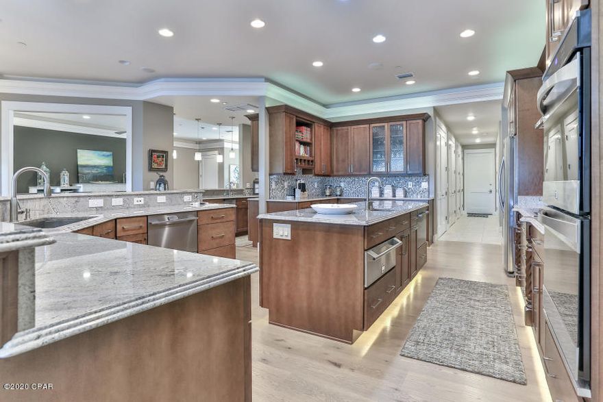 Step into this incredible custom built home and you will never want to leave. The attention to detail and the thoughtful design of the home is evident with every turn. Energy efficient is an understatement with this award winning home. In order to achieve the lowest cost of maintenance and utilities, the owners consulted several professionals from the 3 GEO THERMAL HVAC systems to the LED lighting options. Spray foam insulation on 2X6 walls with full cavity foam and the roof deck specked at 7'' coupled with the Water Furnace 7 Series, variable capacity geothermal unit, surpassing both 41 (EER) and 5.3 (COP). Included on each A/C unit is the Advance Hot Water Generation option, yielding ''Free'' hot water during the warmer months and paired with GE's Geo Sprng Hybd Electric Hot Water Heater Hurricane strength impact glass doors and windows allow you to enjoy the breathtaking view of bayou from every room in the home. The Hunter Douglass custom blinds in all the windows is not only stylish but also provides a soft light that will still maintain privacy. The impact glass door walls open all the way up to the screened lanai where you can enjoy the heated pool and the outdoor kitchen with built in grill. The gourmet kitchen has been functionally designed to create a space where the chef can work and also entertain at the same time.The features are soft close custom wood cabinets and drawers, Stainless Steel appliances, Bosch induction stovetop, convection double oven,
warmer drawer, prep sink in island and all granite counters. All the bedrooms have waterfront views and private full baths. There is a mini theater room just off the upstairs bedrooms for gaming and movie night. The Master is on the main level and has his and her separate closets. Also there is a private entrance from the garage right into the master bath and a private access to the pool lanai from the master bedroom. Laundry room on the main and second floor. No more walking steps with laundry! Washers and dryers convey!
This family really enjoyed entertaining and family time and this floor plan is ideal for both. This one acre estate lot on the peaceful Cinco Bayou is one of five homes in the neighborhood. Privacy, beauty and luxury abound with this home and the natural setting is one of the best lots in Northwest Florida. Make your appointment today.