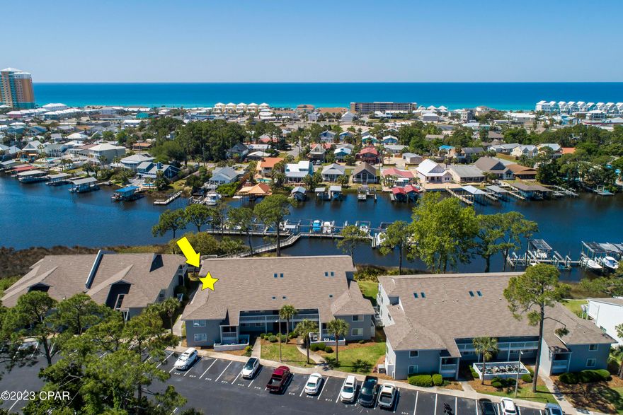 Currently under contract, seller will consider backup offers. The best deal on Grand Lagoon! Paradise awaits you at this outstanding 3 bed, 3 bath unit that comes WITH a deeded boat slip. Enjoy water views from both outdoor patios, one off the primary bedroom, the other off the living area. This spectacular unit features an updated kitchen and flooring throughout the living area. Don't wait, call your agent today!
