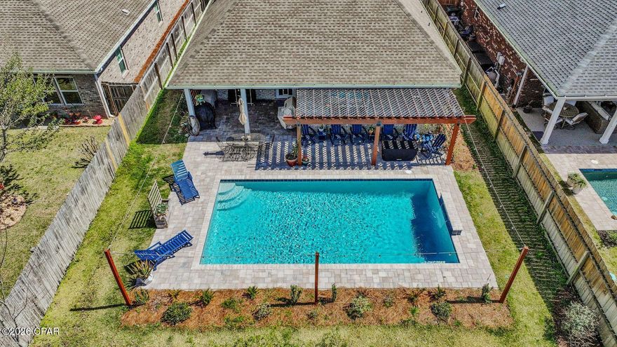 You won't find another home like this on the market. This thoughtfully designed home features three bedrooms and two bathrooms on the first floor, with a fourth bedroom and full bathroom on the second floor, offering the perfect layout for guests, a private suite, or a bonus space.

As you enter the home, you're welcomed by a custom accent wall in the entryway, setting the tone for the stylish details found throughout. The living room features a tray ceiling, adding architectural character and an open feel to the main living space. The primary bedroom also features a tray ceiling, creating a spacious and relaxing retreat.

The kitchen is designed for both everyday living and entertaining, highlighted by an impressive 12-foot island that provides ample prep space, seating, and a natural gathering place for family and guests.

A huge bonus is that tankless water heater that allows all 3 bathrooms to have constant hot water at all times. The Home insurance and Flood Insurance policies on the home total less than $2,000 a year between both policies. The home also has a termite bond that is transferable. 

Step outside to what truly sets this property apart, the backyard retreat. Designed for both relaxation and entertaining, the outdoor space features a stunning in-ground pool, a pergola, and a covered porch, with plenty of room to create your ideal outdoor living area.
The salt water pool in only a year old and still has a warranty.