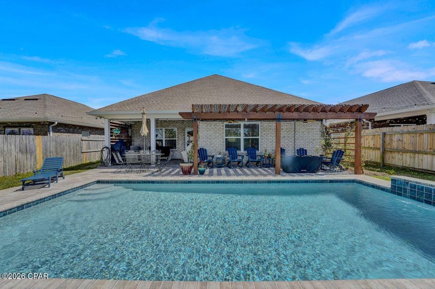 You won't find another home like this on the market. This thoughtfully designed home features three bedrooms and two bathrooms on the first floor, with a fourth bedroom and full bathroom on the second floor, offering the perfect layout for guests, a private suite, or a bonus space.

As you enter the home, you're welcomed by a custom accent wall in the entryway, setting the tone for the stylish details found throughout. The living room features a tray ceiling, adding architectural character and an open feel to the main living space. The primary bedroom also features a tray ceiling, creating a spacious and relaxing retreat.

The kitchen is designed for both everyday living and entertaining, highlighted by an impressive 12-foot island that provides ample prep space, seating, and a natural gathering place for family and guests.

Step outside to what truly sets this property apart, the backyard retreat. Designed for both relaxation and entertaining, the outdoor space features a stunning in-ground pool, a pergola, and a covered porch, with plenty of room to create your ideal outdoor living area.