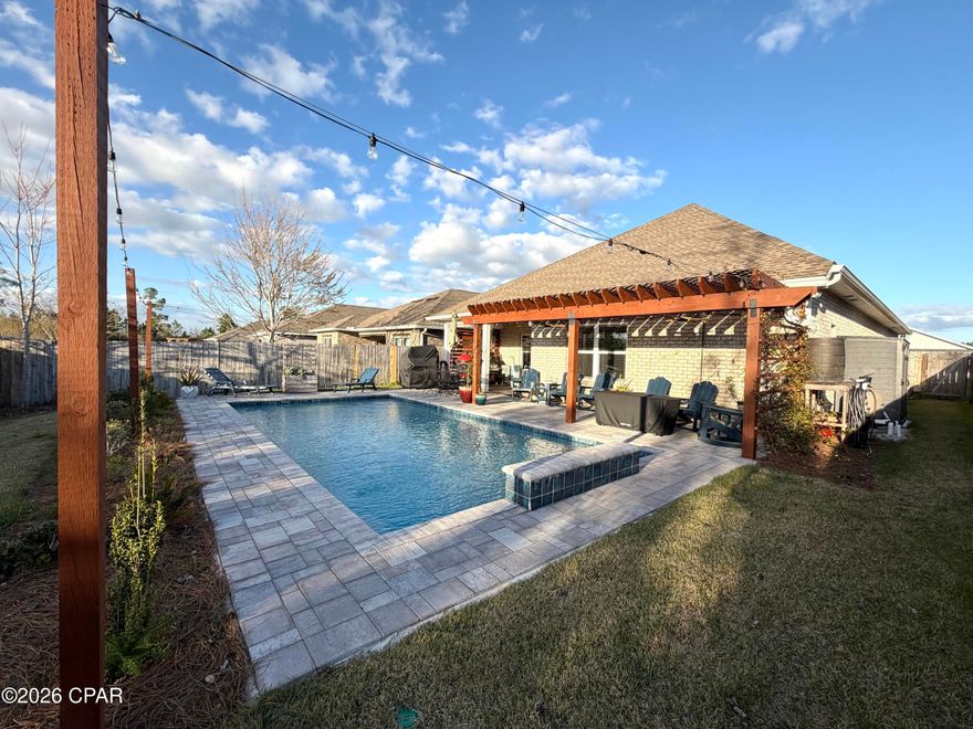 You won't find another home like this on the market. This thoughtfully designed home features three bedrooms and two bathrooms on the first floor, with a fourth bedroom and full bathroom on the second floor, offering the perfect layout for guests, a private suite, or a bonus space.

As you enter the home, you're welcomed by a custom accent wall in the entryway, setting the tone for the stylish details found throughout. The living room features a tray ceiling, adding architectural character and an open feel to the main living space. The primary bedroom also features a tray ceiling, creating a spacious and relaxing retreat.

The kitchen is designed for both everyday living and entertaining, highlighted by an impressive 12-foot island that provides ample prep space, seating, and a natural gathering place for family and guests.

Step outside to what truly sets this property apart, the backyard retreat. Designed for both relaxation and entertaining, the outdoor space features a stunning in-ground pool, a pergola, and a covered porch, with plenty of room to create your ideal outdoor living area.