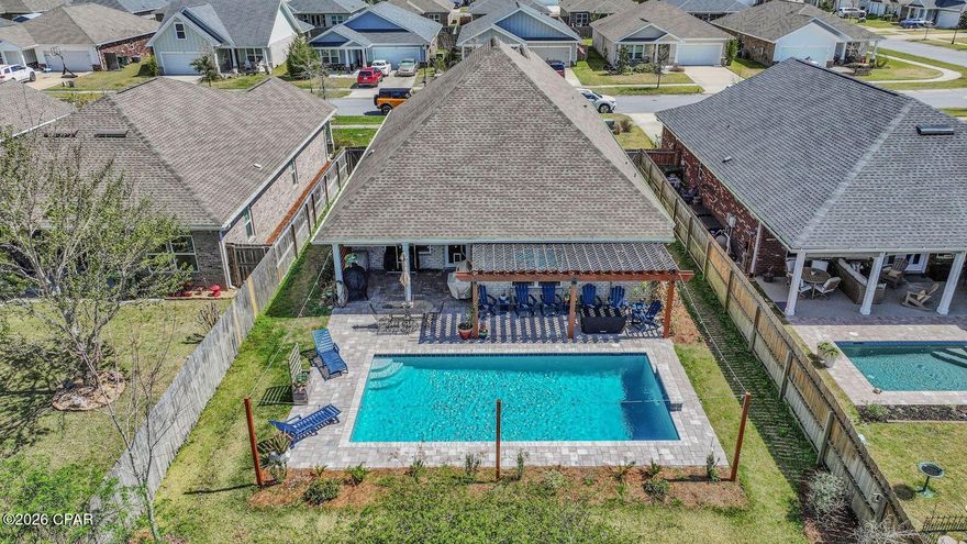 You won't find another home like this on the market. This thoughtfully designed home features three bedrooms and two bathrooms on the first floor, with a fourth bedroom and full bathroom on the second floor, offering the perfect layout for guests, a private suite, or a bonus space.

As you enter the home, you're welcomed by a custom accent wall in the entryway, setting the tone for the stylish details found throughout. The living room features a tray ceiling, adding architectural character and an open feel to the main living space. The primary bedroom also features a tray ceiling, creating a spacious and relaxing retreat.

The kitchen is designed for both everyday living and entertaining, highlighted by an impressive 12-foot island that provides ample prep space, seating, and a natural gathering place for family and guests.

Step outside to what truly sets this property apart, the backyard retreat. Designed for both relaxation and entertaining, the outdoor space features a stunning in-ground pool, a pergola, and a covered porch, with plenty of room to create your ideal outdoor living area.