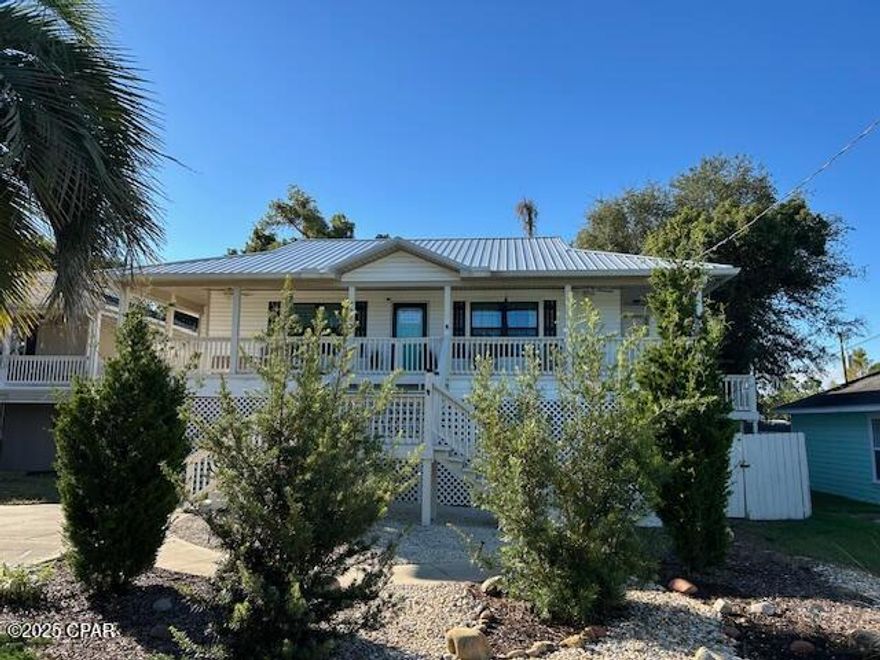 This 3/2 home is coastal living at it's best.  Near Navy base , restaurants, and shopping, It stays high and dry on its stilts with lots of storage space below.  It is nestled in a quiet neighborhood less than 5 minutes from white sandy beaches.   Plenty of curb appeal here with an inviting hardscape in front including an extra parking corral plus a welcoming front porch with fans and Adirondack chairs.  A huge screened porch that opens onto an open deck spans the back of the house for grilling or relaxing.  Outdoor Shower and lots of storage below