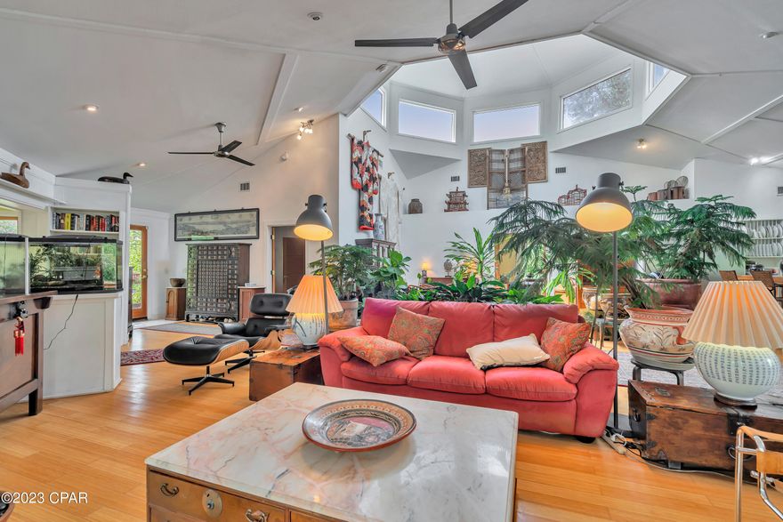 Beautiful custom-built 3 bedroom, 3 bath home on a large 1.38 acres. This unique elevated home has an open and airy floor plan with high ceilings, abundant natural light, a chef's kitchen with SS appliances and a gas stove, solid bamboo flooring (can be refinished up to 5 times), new windows in the copula, wood clad windows, and a new roof. The home is built elevate and under the home there are multiple workspaces, storage, enclosed parking for three vehicles and a greenhouse. This home is in a great neighborhood close to town, but it offers peace and tranquility.