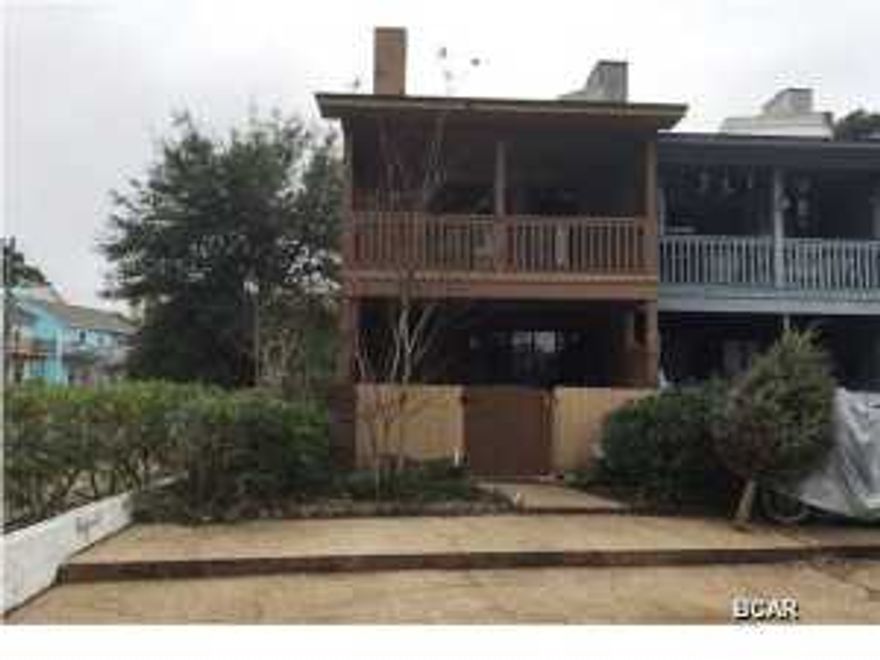 Great location! Across the street from the Lagoon and just 3 blocks from the beach! This end unit townhouse has 2 bedrooms and 2.5 baths. The bedrooms with bathrooms en suite are on the first floor, the living area and half bath on the second floor. The first floor is all tile. The master suite is very comfortable with lots of closet space. French doors lead out to the deck and fenced yard. The large open living room has a fireplace and spacious balcony with views of Grand Lagoon. The kitchen is open to the living room and has a breakfast bar, lots of cabinets and storage.