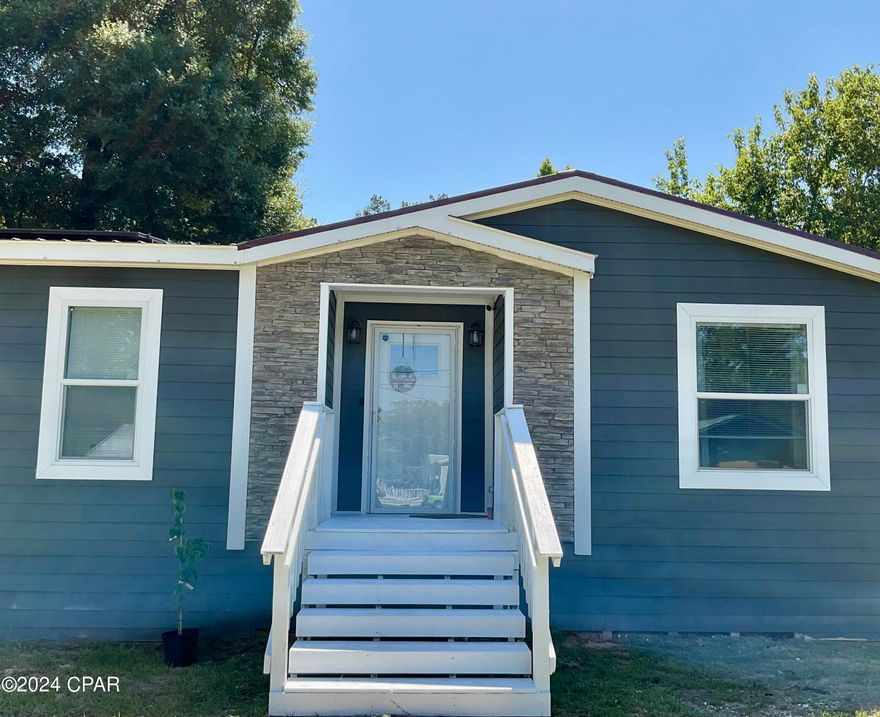 CURRENTLY UNDER CONTRACT, SELLER WILL CONSIDER BACKUP OFFERS. Bright and spacious 2022 custom DWMH with over 2,250 sq. ft. of comfortable living. Upgrades include drywall interior, metal roof, and Hardie Board siding. Located in the quaint town of Vernon. Experience quiet country living just minutes from conveniences like Dollar General Market, local restaurants, post office, gas stations, Holmes Creek, Cotton Landing Recreation Area. Approximately 40 minutes to the beautiful emerald waters of Panama City Beach!  Home includes solar panels for a reduced electric bill each month along with smart Google Nest thermostat. City water/sewer. Generous living room with tray ceiling and wood beam accents, stone veneer electric fireplace, plenty of built-in storage and open floor plan to the kitchen. Kitchen features abundant cabinets, stainless steel sink and appliances, sizable island perfect for entertaining and eat-in area. Master suite can easily fit a king size bed with room to spare, and boasts a substantial walk-in closet with built-in shelving and drawers. Master bathroom features double sink vanity, garden tub, walk-in shower and separate water closet. Three additional bedrooms are well-sized and at the other wing of the home. Second bathroom has a large tub/shower combo and lots of cabinet storage. Separate laundry room includes a stainless steel basin sink, counter space, and cabinetry for seamless laundry days! The backyard is fenced and cross-fenced, includes ample area for backyard BBQs and even an existing pad and pool deck for an above ground pool for hot summer days. Two sheds convey one of which was previously to house former pool pump/accessories. Carport (18x20) fits two sedans easily. Shown by appointment only, 24 hour notice required.