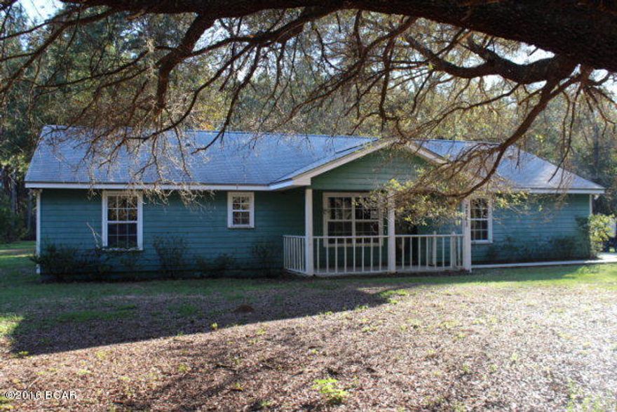 PRICE REDUCED!! This large house on 3.03 acres has so much to offer! It has 4 bedrooms with split bedroom design, a large formal living room, a den with a fireplace and great kitchen with smooth surface range and dishwasher. There is a metal storage building. The location is very nice and secluded but only a short distance out to Hwy 231 where you have an easy access route to Marianna, Cottondale and even Panama City on the coast where you have some of the world's most beautiful beaches. The lot has beautiful large oaks, birds and wildlife to enjoy.