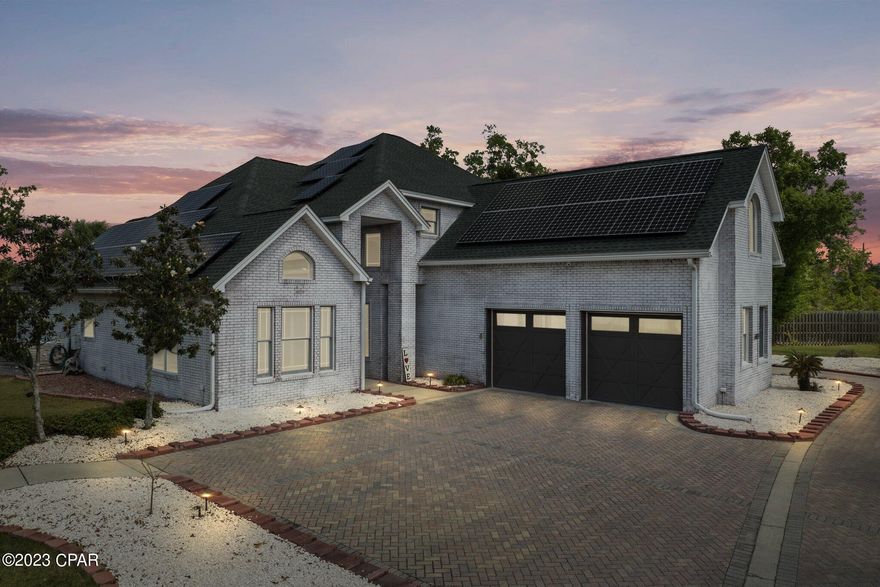 Deer Point Cove Lane, invites you to enjoy this pristine, privately gated, impeccable estate. Located in a small 3 home community, offering a staggering amount of features. You are immediately greeted with an old-world European limewashed exterior & an elongated half circle driveway, 58 solar panels & 2 Tesla Power Walls- large RV parking spaces, 2+ car garage wired for electric charging. Plus a 3rd car detached garage accented with a 2000 bottle wine cellar w/ Vintage View & Sorbus racking, and a fully equipped 11X6 firearms/panic room. PLUS you get a 1/2 acre $100K fully buildable lot sited with power, ready to build or keep for that extra privacy! 2 A/C units, Nest thermostats, Ring doorbell, security cameras, hardwired pathway lighting, sprinkler system, septic & private Econfina well. Inside this majestic castle, you'll find a main floor of ceramic tile, newly remodeled kitchen, extra-large island & full height splash created of exotic marble-granite hybrid. The appliance suite is all GE Café Signature Series. A stunning copper Italian ductless vent hood is the show stopper above the range.
The grand living room with 20' ceilings leads to the beautiful, newly converted saltwater pool & hot tub, all pool equipment such as spa and pool pumps, filtration system and gas pool heater are ALL NEW, with a 2 story Lania. Just off the pool, 1 of 2 pool house/entertainment kitchen awaits you with a fireplace, bar space, extra fridges, microwave, and sound system, for all season entertaining. Across from the entertainment space is another outdoor cook's kitchen with a grill, stovetop, wine fridge, additional fridge (plumbed for an icemaker), prep sink, A/C and a ceiling fan.
Also, off the living room is an exquisitely appointed, main floor 
 massive owner's suite featuring herringbone pattern tile, coffered ceilings, sitting area, double French doors leading to the pool. Newly remodeled bath with seamless, live edge granite counters vessel sinks, a gorgeous soaking tub, enough storage for all your needs & a large shower that features 12' ceilings & 5 shower heads. Upstairs features a stunningly designed, full guest bath that features live edge slab granite, oval vessel sinks, glass enclosed tub/shower combination & frosted glass barn doors for privacy.
The four upstairs bedrooms have large closets & are perfect for family or guests.1 En Suite has a balcony overlooking the Saltwater pool and the estate. The bedroom over the garage would make a fantastic media room conversion due to its abundant size. Old Glory flies high over the front of the estate waving to everyone as they pass by your new gorgeous home.