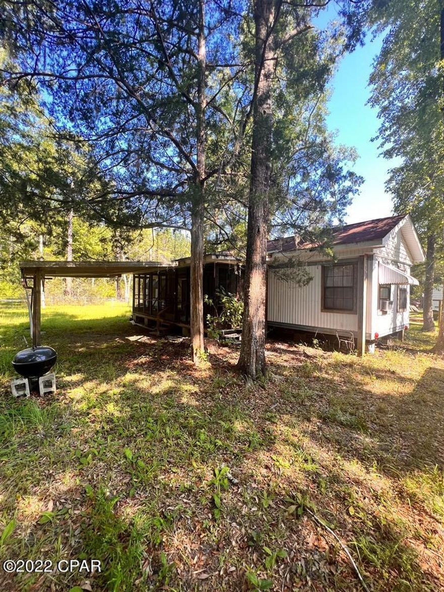 FISHING FOR A WEEKEND GETAWAY? THIS HANDYMAN SPECIAL IS THE IDEAL PLACE TO PARK YOUR BOAT & STORE ALL OF YOUR GEAR! Fenced in for privacy is a 2BD/1BA mobile home w/eat in kitchen & cozy living area. Just off the kitchen is access to a screened in porch for relaxing after a long day on the water. Keep supplies on hand in the storage shed w/room for fishing essentials & kayaks. Located near the Bryant Miller Boat Ramp, access the Chipola River which leads to the Apalachicola River, Intercoastal waterway & the Gulf for fresh & saltwater fishing. Create your own fisherman's paradise in this peaceful natural setting. If you are an outdoor enthusiast, this is the property you've been waiting on within close proximity to Port St. Joe, Wewahitchka or Panama City. HOA fees of $200 per lot annually