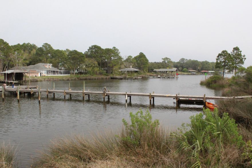 One of the best Views of Lagoon in Villas of St. Thomas Square.  This beautifully ground floor updated 2 bedroom 2 full bath condo has breathtaking views from almost every room. Come sit on the over sized patio and watch the dolphin bring their babies in the lagoon to feed.  Do you have a boat?  Dock space available and boat trailing parking on site.  If you like boating, fishing, kayaking, paddle boarding, etc.  need a place for your boat look NO further. Also, Beach goers just cross the street to the public access and you will be on the white powder sand looking at the beautifully emerald green/blue gulf.  This condo has an Open and Spacious Family Room, Dining Room, Kitchen and Master Bedroom/sitting area that all Look out over the water. Updated Kitchen with stainless steel appliances lots of cabinetry, lovely counter tops.  Light and Bright Master Bedroom Suite is spectacular with a sitting area, newer carpet, walk-in closet with built-ins, and lovely master bath with double vanity, with back splash, lighted mirrors, claw foot tub/shower combo and slider door that leads to over sized patio.  The second full bath includes, upgraded sink, wall mount painted tile from Italy.  Newer ceiling fans, newer lights in kitchen, larger base board, Italian tile flooring throughout both bathrooms and main living space, and much more.....Come and See!!  (Seller is a licensed Florida Realtor)