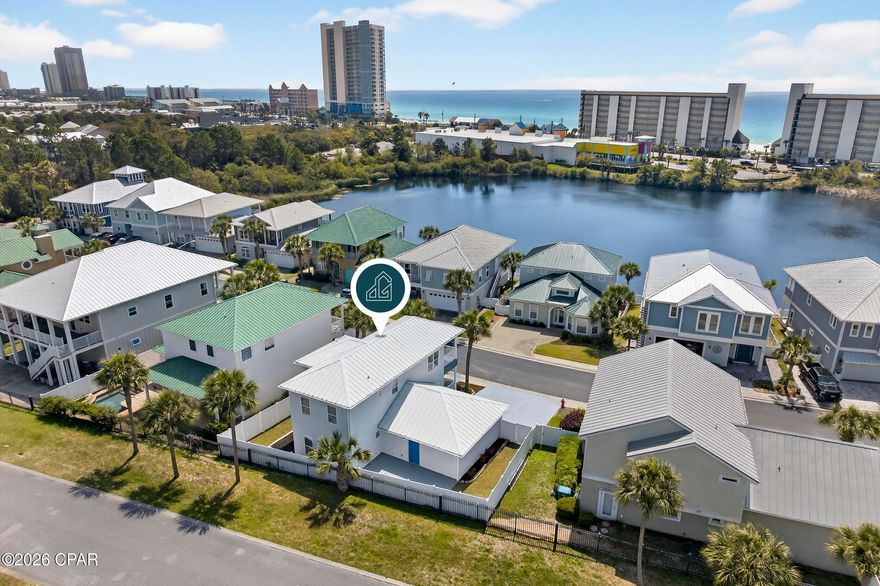 Just steps from the sugar-white sands and emerald Gulf waters, this updated Panama City Beach home offers an exceptional blend of location and comfort - set on a private street just one block from the beach.

Designed for effortless coastal living, this 3BR/3BA two-story home features a bright, open layout with 9-foot ceilings, abundant natural light, and a durable metal roof. Updated 9'' luxury vinyl plank flooring runs throughout, delivering the look of hardwood with the durability and low maintenance ideal for a beach home or rental property. The living, dining, and kitchen areas flow seamlessly, creating a comfortable and inviting space. The kitchen is well-appointed and functional, featuring quartz countertops, a wave-textured backsplash, stainless steel appliances, and a breakfast bar for casual dining. 

The spacious primary suite includes a large walk-in closet and a well-designed bath with a separate shower and tub. A covered balcony offers views from the lake to the Gulf, creating a comfortable outdoor space to enjoy the coastal setting. Two additional bedrooms - one upstairs and one downstairs - each feature their own ensuite bath, providing privacy and flexibility for guests or family. A 2-car garage adds everyday convenience, while outdoor living is just as inviting with a wraparound porch and a freshly updated backyard designed for enjoying the Florida weather.

Extensively improved by the current owner with approximately $112,000 in upgrades, this home is move-in ready with lasting value. Major improvements include a full exterior stucco refresh, updated HVAC, new fencing, resodded yard, and an enhanced sprinkler system. Additional updates such as new exterior lighting, gutters and downspouts, added outdoor power, fresh interior and exterior paint, updated flooring, and a painted garage floor further enhance both function and appearance. A new washer and dryer add everyday convenience, while the ADT security system with cameras provides added peace of mind.

With its prime location near the beach, modern updates, and flexible layout, this Panama City Beach property is well-suited as a primary residence, second home, or investment opportunity. Schedule your private showing to see it for yourself!