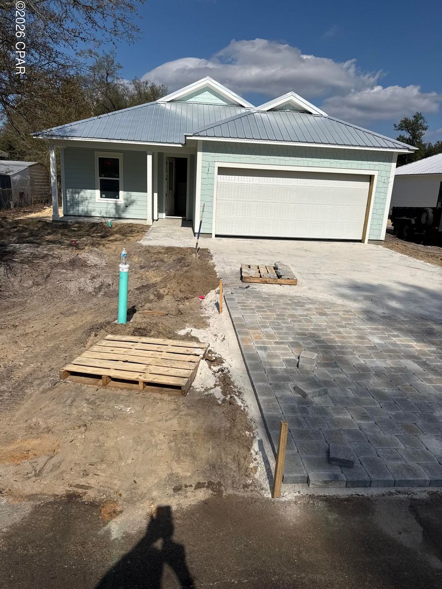 New construction built with impact resistant windows, metal roof, 8'doors throughout. Spray foam insulation in walls and attic, hardy board siding, paver driveway. Quartz countertops, crown molding. Tankless water heater, gas stove.