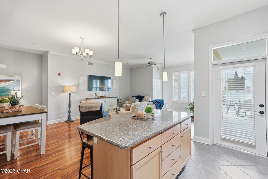 Welcome to Island Reserve, a premier gated community just minutes from the sugar-white beaches of Panama City Beach. This spacious  2nd floor 3-bedroom, 2.5-bath condo offers over 1,761 square feet of thoughtfully designed living space, combining comfort, convenience, and resort-style living in one of the area's most sought-after communities.

Meticulously cared for and freshly painted throughout, this move-in-ready residence features soaring 10-foot ceilings with crown molding, plantation shutters, double-pane windows, and a bright open layout perfect for everyday living or entertaining. The kitchen is beautifully appointed with granite countertops and stainless steel appliances. A furnished option is available, making this an easy transition for a primary residence or second home.

The spacious primary suite offers a spa-like retreat with a soaking tub, walk-in shower, double vanity, large walk-in closet, and private access to the expansive wrap-around covered porch--the perfect place to enjoy morning coffee and peaceful views of the lush community grounds. Two guest bedrooms share a convenient Jack-and-Jill bath, and a dedicated laundry room adds everyday convenience.

One of the standout features of this unit is its unbeatable accessibility: the adjacent covered parking garage is located right outside the door.

Island Reserve offers a true resort lifestyle with a spectacular 1-acre lagoon pool featuring waterfalls, lap area, zero-entry access, hot tub, and outdoor showers. Residents also enjoy a beautifully appointed clubhouse with a fitness center, indoor basketball and pickleball courts for year-round play, theater room with a 100-inch screen, game room, and an active social calendar. The community is pet-friendly, VA-approved, and known for its lush tropical landscaping, gated security, and welcoming atmosphere.

Located just minutes from the Gulf, shopping, dining, golf, and entertainment, this beautifully maintained condo delivers the perfect blend of luxury, location, and low-maintenance living. With no short-term rentals permitted, Island Reserve offers a peaceful residential environment while still being close to everything Panama City Beach has to offer.

Experience effortless coastal living with resort-style amenities right outside your door--this is Island Reserve at its finest.