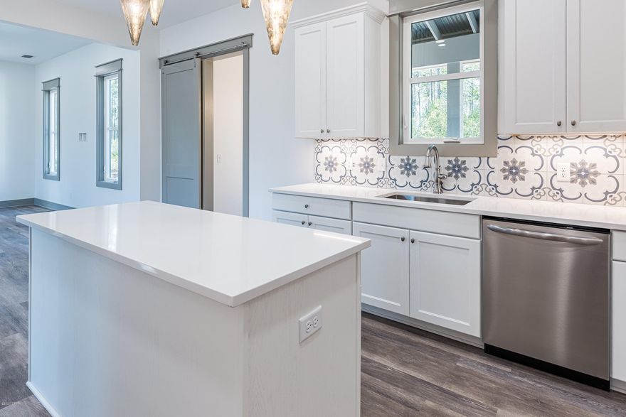 Accepting back-up Offers. Contingent sale. Upscale new construction retreat in the gated reserve of RiverCamps on Crooked Creek. Enjoy the modern rustic design in this 3 BR/3.5 BA home with 2-car garage. The first floor has 10' ceilings and includes a guest suite, powder room, and large kitchen overlooking an open concept living/dining area, plus a spacious screened in porch that is perfect for entertaining! The 2nd floor has 9' ceilings includes a master suite, laundry room, loft space, and an additional bedroom. Notable features include quartz kitchen counters, oak shaker style cabinetry, designer light fixtures, luxury vinyl plank flooring with carpet in bedrooms, Venetian Marble countertops and subway tile in bathrooms. Exterior features include Aged Pewter Hardie plank siding with arctic white trim and a corrugated metal roof. RiverCamps is a coastal sanctuary designed to embrace the outdoors that is bordered by water on 3sides, the Intracoastal Waterway, Crooked Creek and the spectacular 18,000-acre West Bay. RiverCamps community offers outstanding amenities such as a RiverHouse with swimming pool, and pavilion, a fitness center, trails and boardwalks, and a boat ramp with access to the Gulf of Mexico.