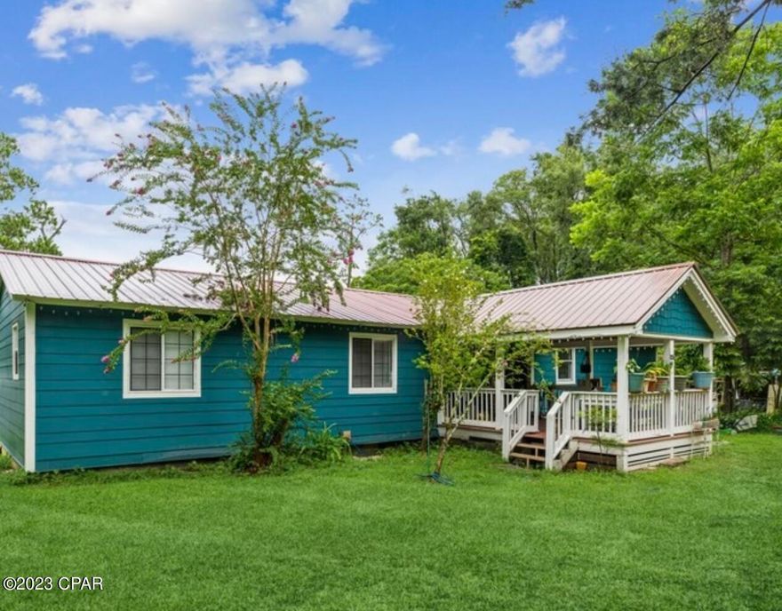 Needing both space to accommodate a larger family and affordability? Well look no further!  4 Bedroom/3 Bath move-in ready home with open concept living space sitting on .48 acre on a quiet street within city limits. New large front porch addition and custom updates throughout gives this home a modern coastal vibe. All bathrooms are upgraded.  There are TWO master bedrooms on opposite ends of home both with walk-in closets and tile showers. The kitchen boasts a huge bar with new cabinets, tile back splash, quartz countertops, and a pantry for storage which leads out to back porch. Large covered back porch gives you space for all your extras! Flood insurance required.