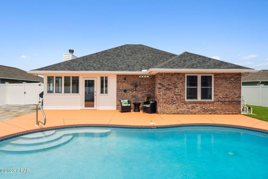 Welcome to this beautifully maintained home located in the heart of Lynn Haven. This home boasts lush green landscaping and a newly resurfaced concrete saltwater pool enclosed in a 6 foot vinyl privacy fence with a workshop and beautiful pavers for outdoor entertainment! There is an enclosed Florida room on the back of the house giving the opportunity to dine under amazing western sunsets overlooking the pool. This home has tile, LVP and carpet throughout the house and a beautiful brick fireplace in the living room. The kitchen has tall windows looking out to the front of the well manicured front yard. The three bedrooms are spacious while the larger master bedroom has a large walk in closet and new walk-in tiled shower. 1714 Scarlett Blvd is centrally located and close to shopping, restaurants and medical services. The home is also only a short 20 minute drive to the most beautiful beaches in the country, 30 minutes to Tyndall Air Force Base and one block from Cain Griffin Park.