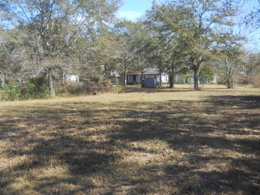All information is taken from Public Records.  If important to buyer please verify.  Huge lot located at the end of a paved and private cul-de-sac.  Property is located in Southport and has a small pond on the property.  Property is mostly cleared and has older mobile home and other improvements in poor condition and would need lots of work or removed.  Property has a well and septic tank.  Value is in the land.